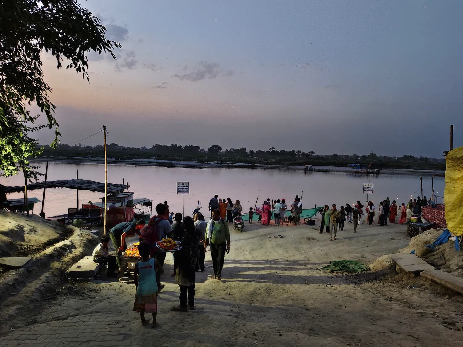Keshi Ghat at dusk, pilgrims gathered along the sandy bank where the Yamuna widens past Vrindavan